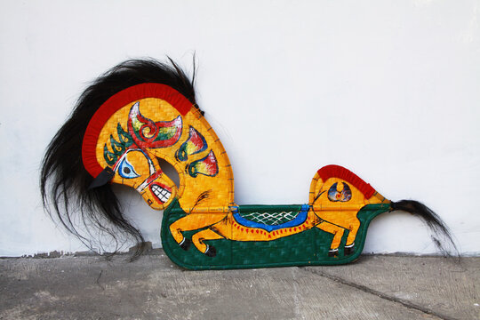 Traditional Indonesian Javanese horse props made from woven bamboo, featuring colorful hand-painted patterns, black horsehair details, and distinctive cultural craftsmanship displayed against a white 