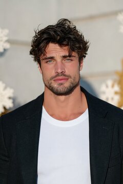 Outdoor portrait of bearded man with tousled hair on neutral winter background with snowflakes for headshot and banner design