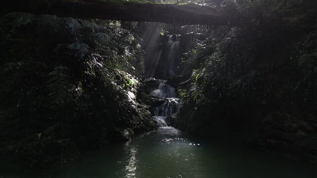 Mysterious Waterfall Deep Inside Ioki Cave in Kochi, Japan with Sunbeams and Dripping Water &ndash; Aerial Drone Footage