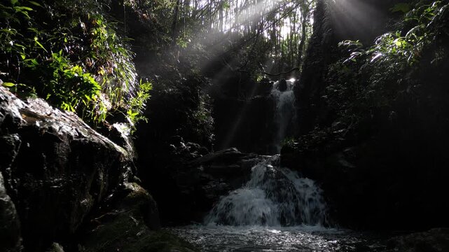 Mysterious Waterfall Deep Inside Ioki Cave in Kochi, Japan with Sunbeams and Dripping Water &ndash; Aerial Drone Footage