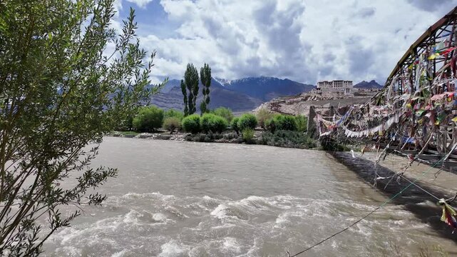 Ladakh, India : Panoramic footage of the bridge with prayer's flag above Indus river connecting to Stakna Gompa, a famous Buddhist monastery near Leh in Ladakh, Indian Himalayas mountain range.