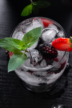 Close Up of Sparkling Fruit Drink With Ice Berries Strawberries and Mint