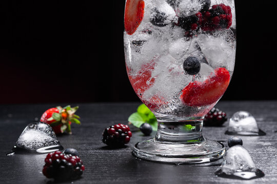 Close Up of Sparkling Fruit Drink With Ice Berries Strawberries and Mint