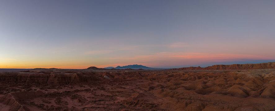 Aerial view of Goblin Valley State Park with its unique sandstone hoodoos and rugged desert landscape under a soft sunset sky in Green River, Utah, United States.