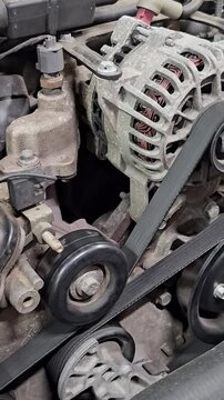 Mechanic checks engine parts in a workshop in the afternoon