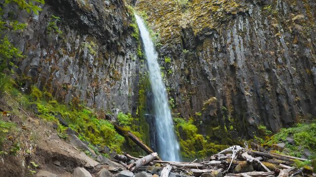 Dry Creek Falls drops into a rocky basin beneath steep basalt walls and green Oregon forest, actual speed
