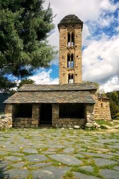Front view of historic romanesque stone church Esgl&eacute;sia de Sant Miquel d'Engolasters with high bell tower and slate roof in Escaldes-Engordany Andorra Pyrenees mountain travel stock background is