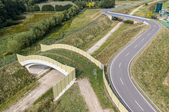 Aerial view of a wildlife crossing bridge with sound barriers over a bypass road in Celle, Germany.