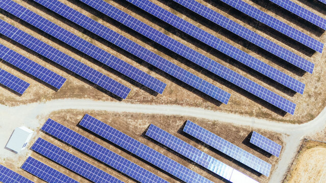 Aerial view of solar panels arranged in rows at a solar farm in the countryside of Sabac, Vojvodina, Serbia.