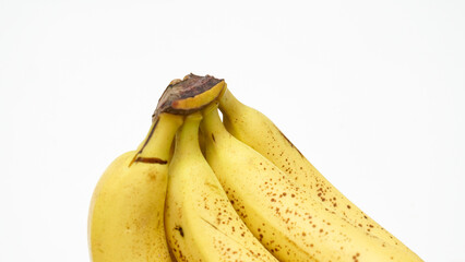 Bunch of Bright Yellow Ripe Bananas Against a Crisp White Background © indraprojects