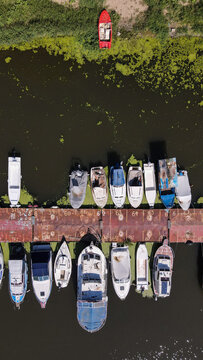 Aerial view of various boats docked at a numbered pier at Ada Ciganlija, Belgrade, City of Belgrade, Serbia.