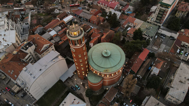 Aerial view of St. Anthony of Padua Church with its distinctive brick tower and green dome, surrounded by urban rooftops and streets in Belgrade, City of Belgrade, Serbia.