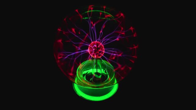 A mesmerizing video shot of a glowing plasma ball sphere discharging bright electrical tendrils in red, pink, and purple.