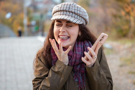 Female celebrating a personal milestone while holding smartphone. Motivation and happiness concept.