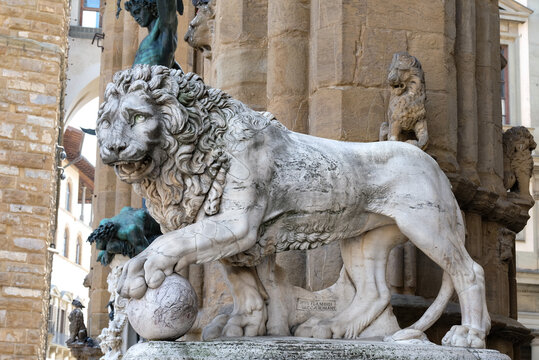 Medici Lion holds the globe in Piazza della Signoria. Marble Renaissance lion statue at the entrance of Loggia dei Lanzi in Florence