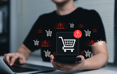 E-Commerce Warning and Shopping Cart Risk Concept. Woman using laptop and smartphone with shopping cart icons, online purchase issues, checkout risk, transaction warning, e-commerce security concerns © Sandwish