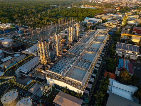 Aerial view of PLTDG Pesanggaran Diesel and Gas Power Plant with industrial structures, cooling towers, and storage tanks in Denpasar Selatan, Bali, Indonesia.