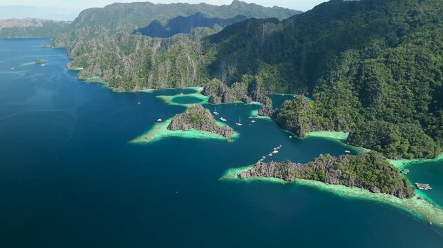 Aerial view of tropical Coron Island archipelago in Palawan Philippines featuring limestone cliffs and turquoise lagoons.