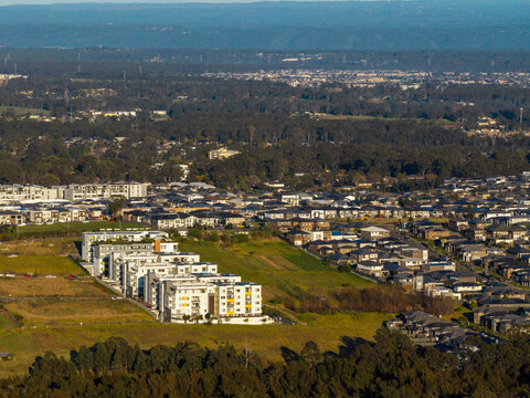 Aerial view of modern apartment developments and residential housing in the urban fringe of Schofields, New South Wales, Australia.