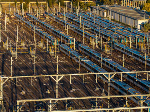 Aerial view of driverless metro trains parked in a train stabling yard with overhead electrification infrastructure in Tallawong, New South Wales, Australia.