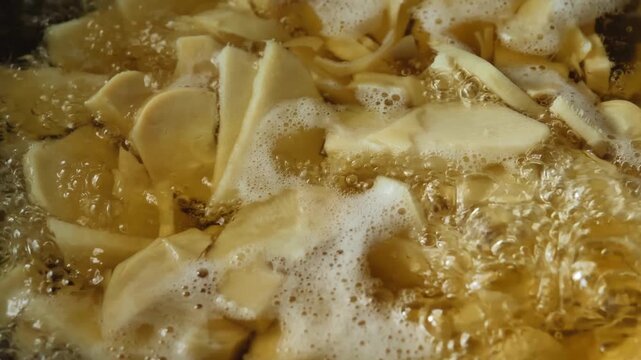 Fresh bamboo shoots boiling in a cooking pot, showing the preparation process and natural texture of the bamboo shoots.