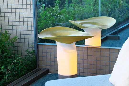 Illuminated modern outdoor lamps on a contemporary terrace