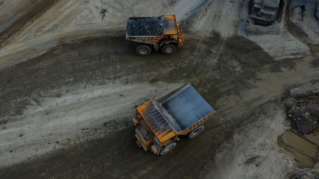 Aerial view of two large yellow mining dump trucks operating in the open-pit copper mine at RTB Bor Grupa - Rudnik Bakra Majdanpek, Majdanpek, Borski okrug, Serbia.