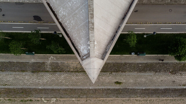 Aerial view of the triangular roof structure of Sportski centar 25. maj, featuring adjacent roads, paved walkways, and green spaces in Beograd, Grad Beograd, Serbia.
