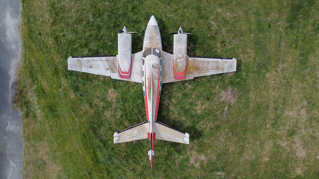 Aerial view of a twin-engine propeller aircraft parked on the grass at Lisiciji Jarak Airport, Padinska Skela, Grad Beograd, Serbia.