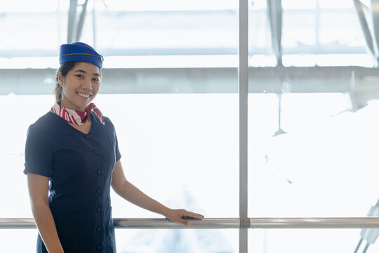 Airport ground service person, Asian beauty woman airline uniform standing happy smiling in airport