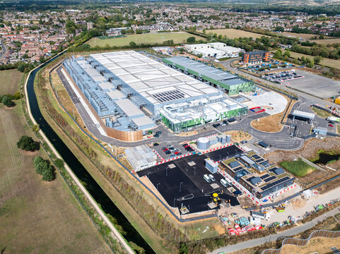 Aerial view of the Google Data Centre in Waltham Cross, featuring large industrial buildings, solar panels, and surrounding infrastructure in Cheshunt, England, United Kingdom.