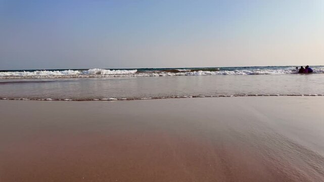 Small Group Enjoying Incoming Bay of Bengal Waves at Niladri Beach, Puri