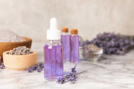 Lavender essential oil in glass and bottles with fresh lavender fowers. Natural aromatherapy. Organic skincare. Herbal cosmetic serum. Spa wellness treatment. Botanical Extract, beauty and self care