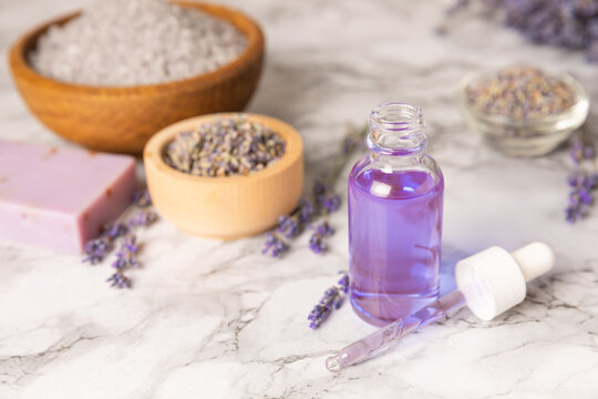 Lavender essential oil in glass and bottles with fresh lavender fowers. Natural aromatherapy. Organic skincare. Herbal cosmetic serum. Spa wellness treatment. Botanical Extract, beauty and self care