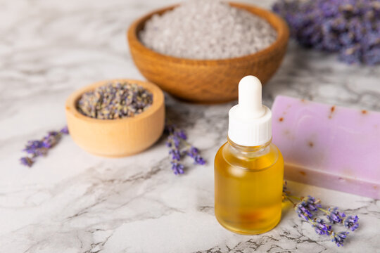 Lavender essential oil in glass and bottles with fresh lavender fowers. Natural aromatherapy. Organic skincare. Herbal cosmetic serum. Spa wellness treatment. Botanical Extract, beauty and self care