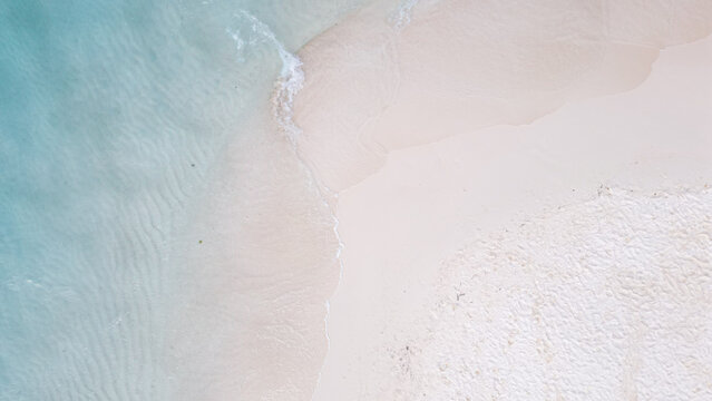 Aerial view of Pasir Timbul sandbar surrounded by turquoise water and white sand in Raja Ampat, Papua Barat Daya, Indonesia.