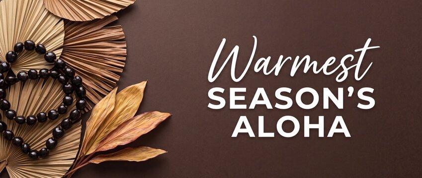 Hawaiian Christmas greeting Warmest Season's Aloha card featuring black kukui nut lei and dried tropical palm leaves on brown background for festive holiday season banner and Polynesian celebration.