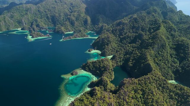 Aerial view of turquoise lagoons and lush tropical limestone karst islands in Coron Palawan Philippines.