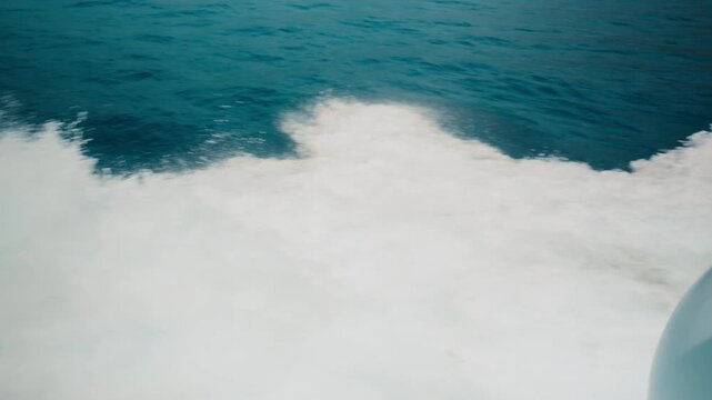 Rolling wall of white foam breaking beside a dark blue sea traveling to Amalfi
