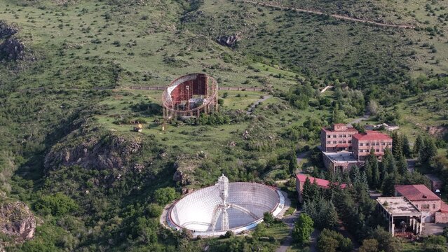 Aerial view of the Radio Optical Observatory ROT-54 featuring its massive parabolic antenna set within the rugged green hills of Orgov, Aragatsotn Province, Armenia.