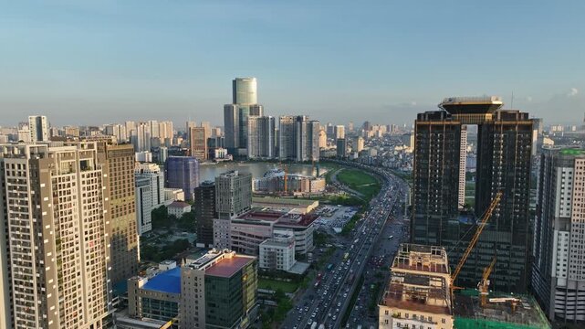 Elevated view of Pham Hung Road with dense traffic, high-rise buildings, residential towers, and the modern urban skyline of Hanoi, Vietnam.
