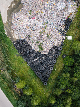 Aerial view of a landfill site with a massive pile of discarded tires and mixed consumer waste, highlighting environmental challenges in Laidzes pagasts, Talsu novads, Latvia.