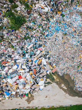 Aerial view of a large landfill site showing piles of mixed waste, discarded furniture, and debris, highlighting environmental challenges in Laidzes pagasts, Talsu novads, Latvia.