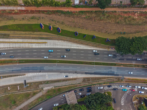 Aerial view of the BSD City signage on a grassy slope beside a multi-lane highway with traffic flowing through Serpong Sub-District, Banten, Indonesia.