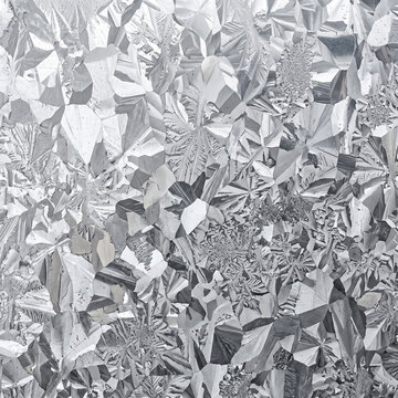 Textured zinc crystal surface with intricate metallic patterns  