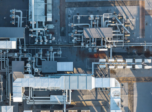 Aerial view of the complex industrial HVAC systems, ventilation ducts, and piping on the roof of a data centre in Gdynia, Pomeranian Voivodeship, Poland.