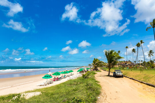 Tropical Beach Coastline with Umbrellas and Off Road Vehicle