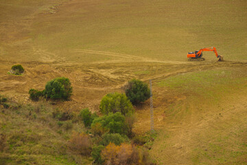 Digger excavator on field. © anetlanda
