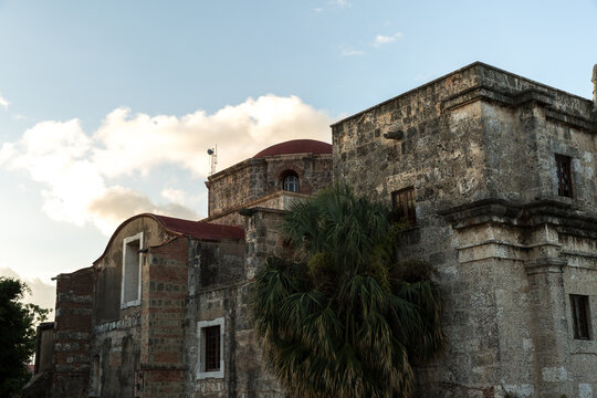 Historic Stone Church Facade with Red Domes