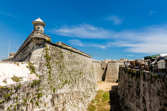 Ancient Stone Fortress Wall with Watchtower and Moat